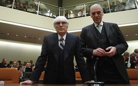 F1 supremo Bernie Ecclestone (L) arrives as witness with his lawyer Sven Thomas for the trial against former CEO of Bayerische Landesbank and F1 chairman Gerhard Gribkowsky