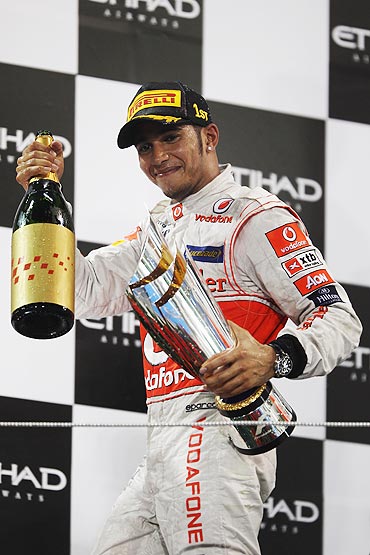 Lewis Hamilton of McLaren celebrates on the podium after winning the Abu Dhabi Formula One Grand Prix