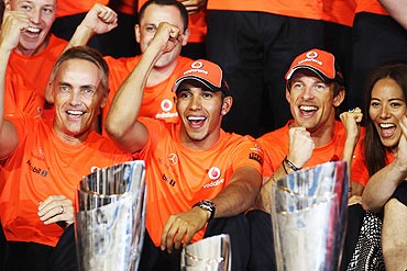 Lewis Hamilton (2nd left) of McLaren celebrates with his Team Principal Martin Whitmarsh (left), Jenson Button (2nd right) and Button's girlfriend Jessica Michibata (right)
