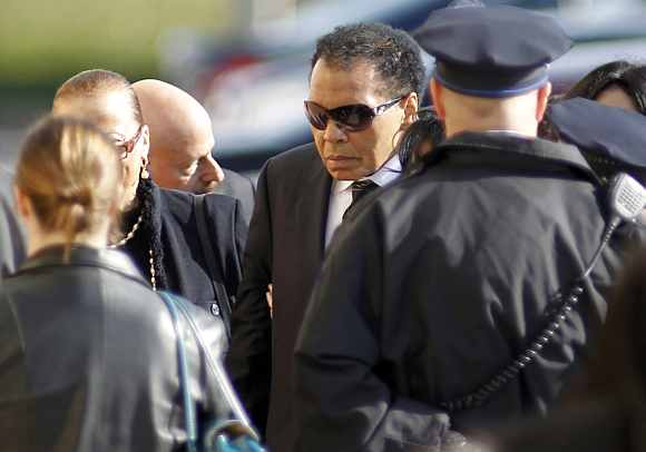 Boxing great Muhammad Ali enters the funeral for boxer Joe Frazier at the Enon Tabernacle Baptist church in Philadelphia