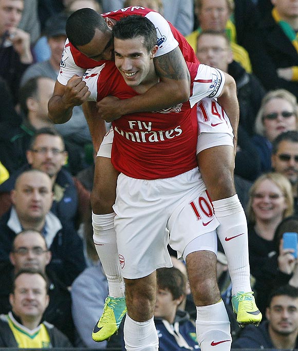 Arsenal's Robin Van Persie (right) celebrates with teammate Theo Walcott after scoring against Norwich City