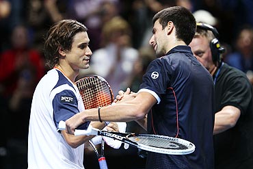 David Ferrer (left) greets Novak Djokovic
