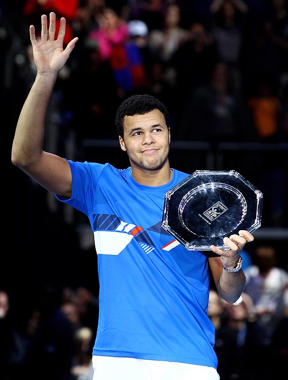 Jo-Wilfried Tsonga holds his runners up trophy after losing to Roger Federer