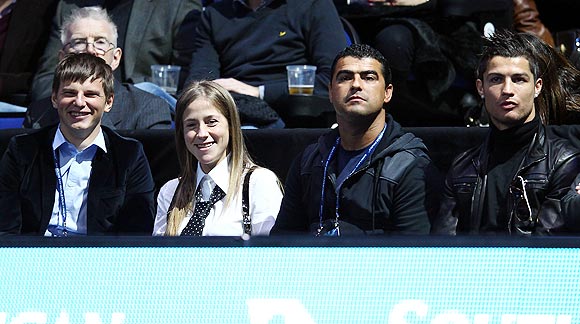 Arsenal footballer Andrey Arshavin (left) his wife, Yulia (2nd from left), Real Madrid's Cristiano Ronaldo (right) and a friend watch the  World Tour finals on Sunday