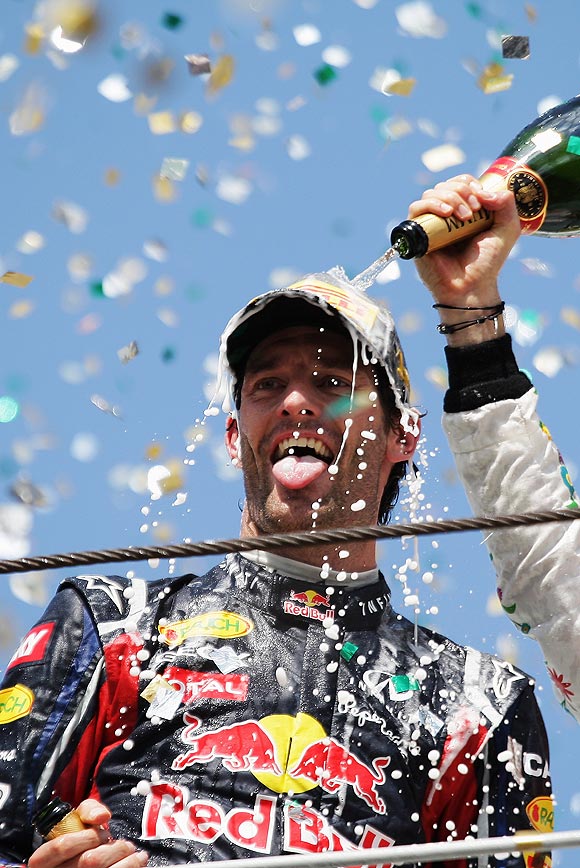 Red Bull's Mark Webber celebrates on the podium after winning the Brazilian Grand Prix on Sunday