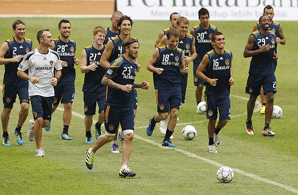 David Beckham and his Los Angeles Galaxy teammates go through the grind during a training season at Bung Karno stadium in Jakarta