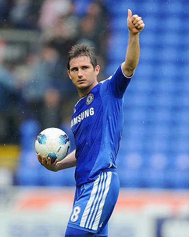 Frank Lampard of Chelsea celebrates with the match ball after scoring a hat-trick during the Barclays Premier League match against Bolton Wanderers on Sunday