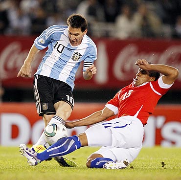 Argentina's Messi fights for the ball with Chile's Beausejour during their World Cup 2014 qualifying football match