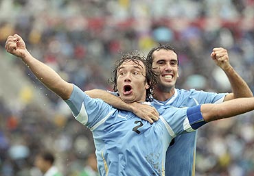 Uruguay's Diego Lugano (left) celebrates with team-mate Diego Godin after scoring against Bolivia during their World Cup qualifying football match