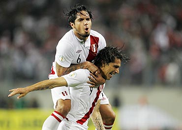 Peru's Paolo Guerrero (right) celebrates with team-mate Juan Vargas after scoring against Paraguay during their 2014 World Cup qualifying football match
