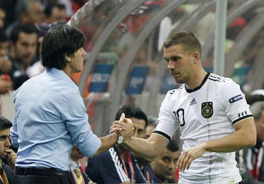 Germany's Lukas Podolski (right) is congratulated by head coach Joachim Loew during their Euro 2012 qualifying Group A match