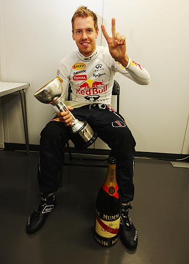 Sebastian Vettel celebrates in his changing room with the third place trophy after the Japan GP on Sunday