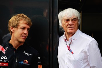 F1 supremo Bernie Ecclestone (right) talks with Sebastian Vettel