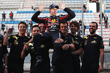 Sebastian Vettel celebrates with team-mates as they win the Constructors title following his victory in the Korean Formula One Grand Prix