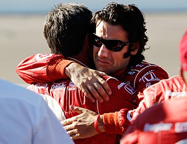 Dario Franchitti, driver of the 10 Target Chip Ganassi Racing Dallara Honda hugs a crew member after the death of Dan Wheldon