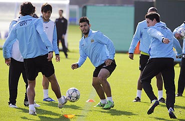 Manchester City's Aguero fights for the ball during a practice session at the club's Carrington training complex