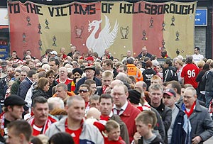 Liverpool Football Club supporters queue to enter a memorial service at Liverpool's Anfield stadium to mark the 20th anniversary of the Hillsborough disaster