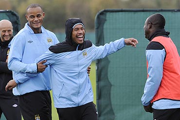 Manchester City's Vincent Kompany (left), Nigel De Jong (centre) and Micah Richards (right) joke around during a practice session