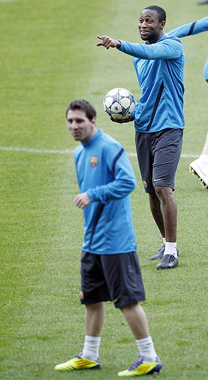 Barcelona's Lionel Messi and Seydou Keita attend a training session at Camp Nou stadium in Barcelona