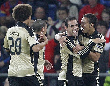 Benfica's Bruno Cesar (centre) celebrates with teammates after scoring against FC Basel