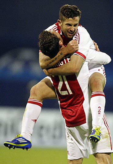 Derk Boerrigter and Miralem Sulejmani (top) of Ajax Amsterdam celebrate after scoring against Dinamo Zagreb