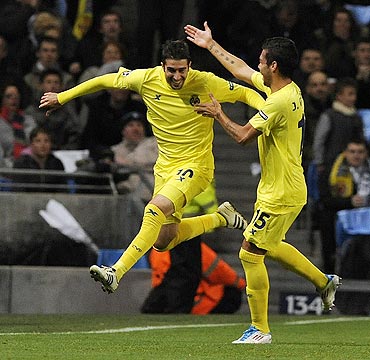 Villarreal's Cani (left) celebrates with Jose Catala after scoring against Manchester City