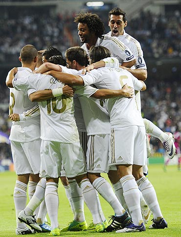 Real Madrid's players celebrate after Karim Benzema scored against Olympique Lyon