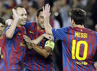 Barcelona's Andres Iniesta (left) is congratulated by teammates after scoring against Viktoria Plzen