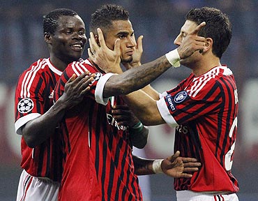 AC Milans's Kevin-Prince Boateng (centre) celebrates with his teammates Taye Taiwo (left) and Daniele Bonera
