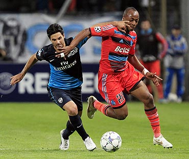 Olympique Marseille's Andre Ayew (right) challenges Arsenal's Mikel Arteta