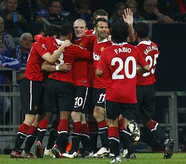 Manchester United players celebrate after winning a match