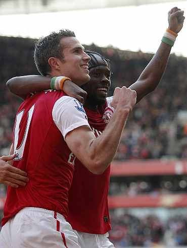 Robin van Persie celebrates with teammate after scoring against Stoke City
