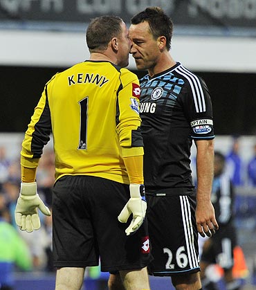 Queen's Park Rangers's goalkeeper Paddy Kenny (left) and Chelsea's John Terry confront each other during their EPL match on Sunday