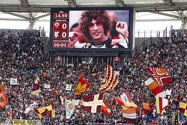 A picture showing the italian MotoGP rider Marco Simoncelli is seen on a giant screen before the Italian Serie A soccer match in Rome