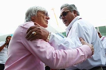 F1 supremo Bernie Ecclestone talks with Force India Chairman Vijay Mallya (right)