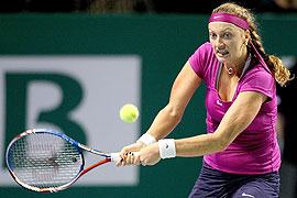 Petra Kvitova of the Czech Republic returns a shot to Caroline Wozniacki of Denmark