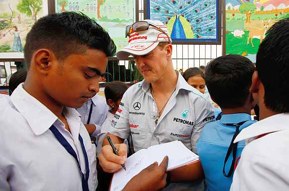Michael Schumacher signing autograpghs for fans at the Buddh International Circuit