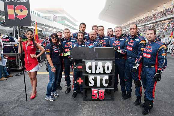 Scuderia Toro Rosso team pay their respects to Italian Moto GP rider Marco Simoncelli