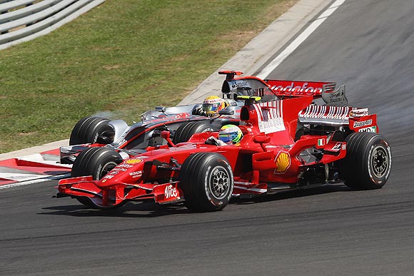 Felipe Massa of Brazil and Ferrari goes past Lewis Hamilton of Great Britain