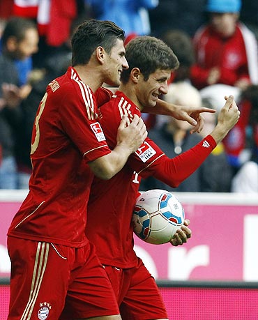 Munich's Mario Gomez and Muller celebrate a goal
