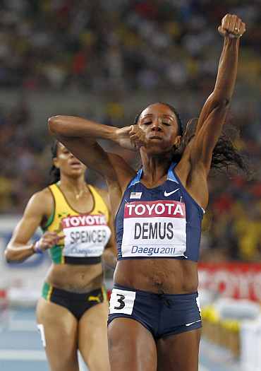 Lashinda Demus of the U.S. celebrates next to Spencer of Jamaica after winning the women's 400 metres hurdles final