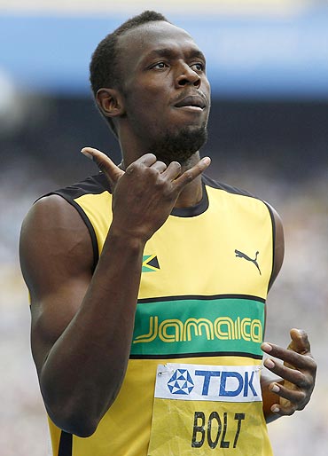 Usain Bolt gestures after winning his men's 200 metres heats on Friday