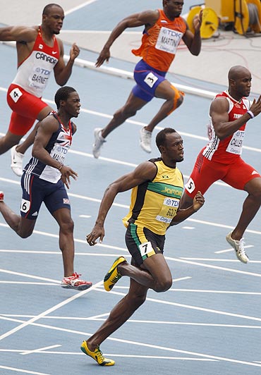Usain Bolt leads the pack during his men's 200 metres heats