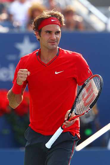Roger Federer celebrates after winning his match against Marin Cilic
