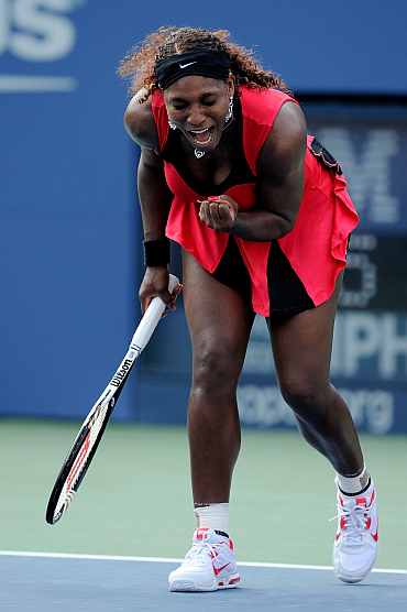 Serena Williams react after winning her match against Victoria Azarenka