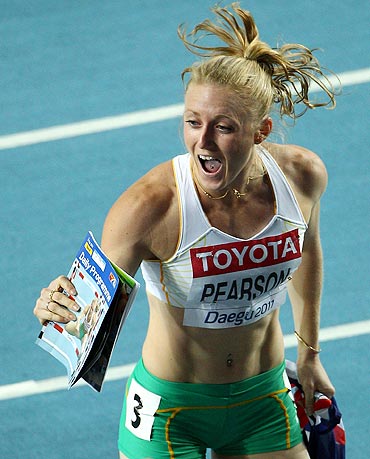 Sally Pearson celebrates victory in the women's 100 metres hurdles final