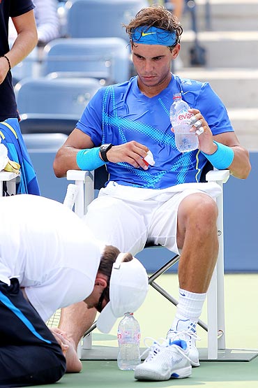 Rafael Nadal gets his foot taped up by trainer Clay Sniteman during his match against David Nalbandian