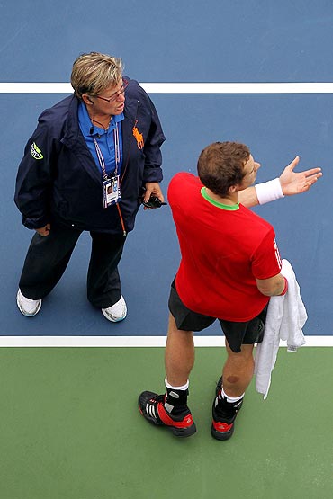 Andy Murray (right) talks with WTA tour director Pam Whytcross following delay in play against Donald Young