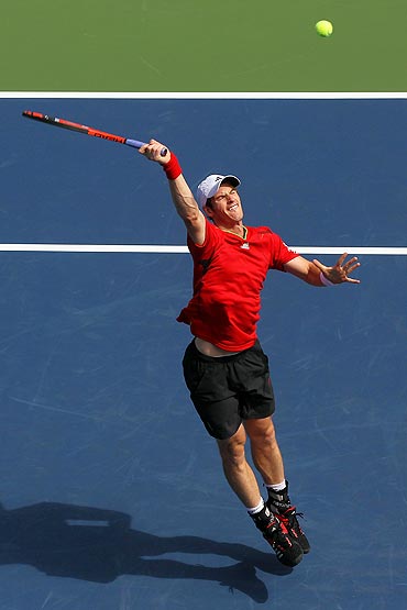 Andy Murray returns a shot against Donald Young