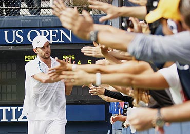Andy Roddick (left) greets fans after defeating David Ferrer